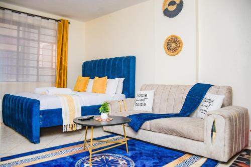 a living room with a bed and a couch at lexy homes in Ruiru