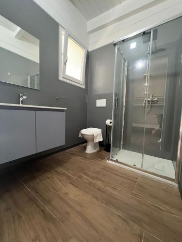 a bathroom with a glass shower and a toilet at Aquarius Policoro in Policoro