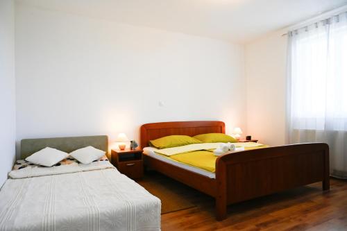 a bedroom with two beds and a window at Villa Kapitulac in Grižane