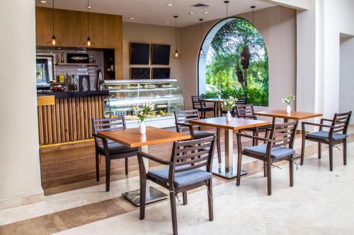 a restaurant with wooden tables and chairs and a counter at Dreams Playa Bonita All Inclusive in Playa Bonita Village