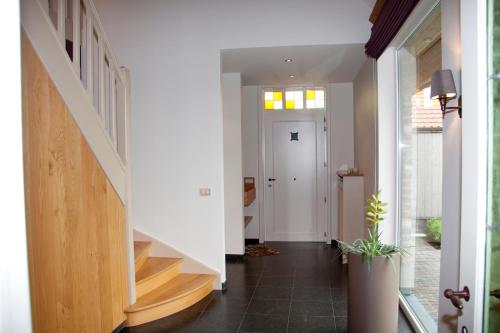 a hallway with stairs leading to the front door at Vakantiehuis 1 - Ter Douve in Heuvelland
