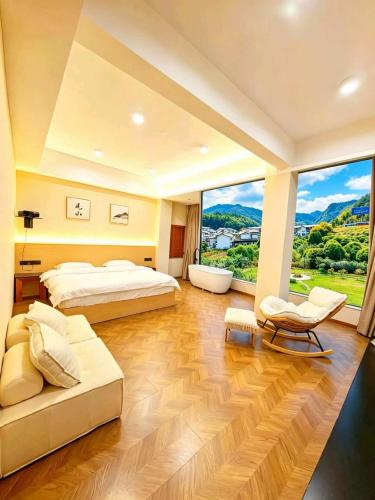 a large bedroom with two beds and a large window at NAIYI Forest Park Resort in Zhangjiajie