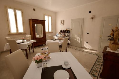 a dining room with tables and chairs and a mirror at B&B Residence il Ciliegio , Via Villa Superiore 93 Luzzara in Luzzara