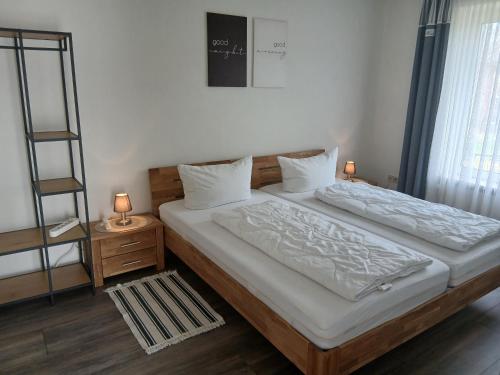 a bedroom with two beds and a book shelf at Ferienhaus No.10 in Hemmoor