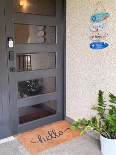 a door with a welcome mat in front of it at The Beach Loft by Xio in Humacao