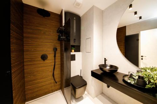 a bathroom with a sink and a mirror at Еlite central stay apartment in Pleven