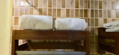 two towels sitting on a shelf in a bathroom at 4S Hotel Dahab in Dahab