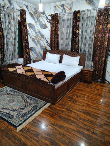 a bedroom with a bed with a checkered at Minnat Home Stay in Srinagar