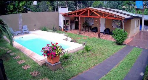a backyard with a swimming pool and a house at La Rufina Lodge in Puerto Iguazú