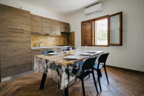 a kitchen with a table with chairs and a sink at Lucia House in Santa Lucia