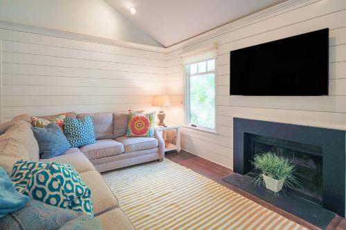 a living room with a couch and a fireplace at Fiddlers Hideaway in Kiawah Island