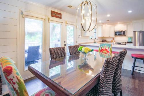 a kitchen with a glass table and chairs at Fiddlers Hideaway in Kiawah Island