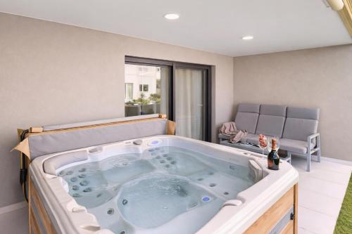 a large jacuzzi tub in a room at Apartment Grape Panorama Mar Punta Prima in Punta Prima