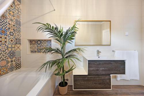 a bathroom with a sink and a plant in it at Encanto dos Montes in Alvor