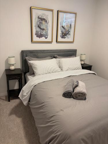 a bedroom with a large bed with two night stands at Cobblebrook Executive Suites in Airdrie