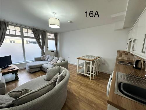 a living room with a couch and a table at Dorchester Town Centre Entire Apartment in Dorchester