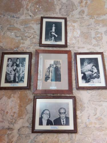 a group of framed pictures on a stone wall at Hotel Valide Hanim Konak in Lefkosa Turk