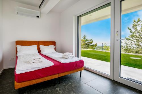 a bedroom with a bed and a sliding glass door at Apartment La Lita Panoramic Sea View Parking Self Checkin in Šmarje