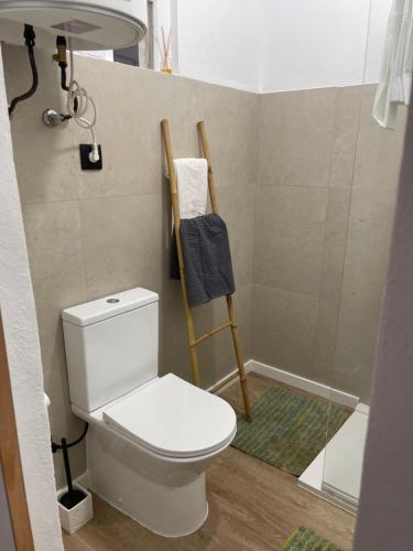 a bathroom with a toilet and a shower at Casa Alto da Vela in Peniche