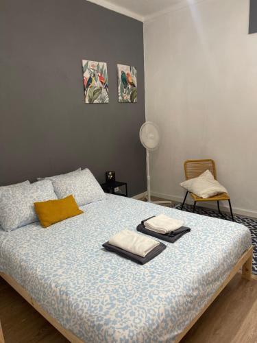 a bedroom with a bed with towels on it at Casa Alto da Vela in Peniche