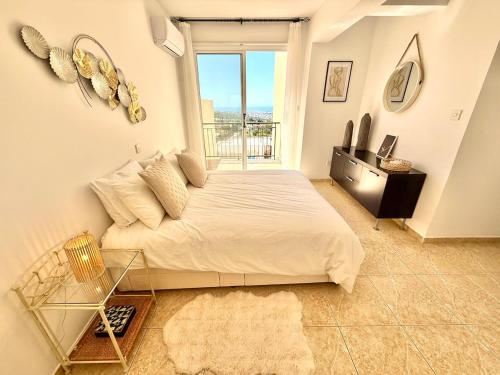 a bedroom with a large bed and a window at Tala Panorama View in Tala