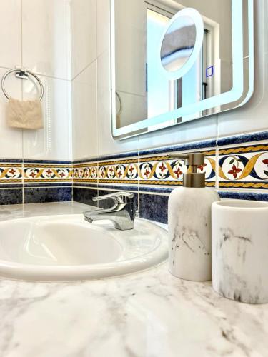 a bathroom with a sink and a mirror at Tala Panorama View in Tala