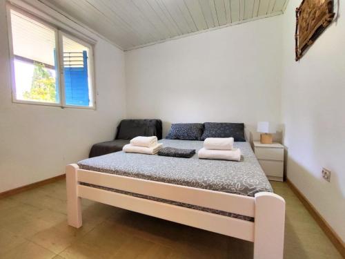 a bedroom with a bed in a room with a window at Apartments Skipper bay Kumbor in Herceg-Novi