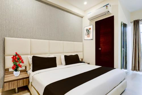 a bedroom with a large bed and a red door at Townhouse Hotel Sec- 54 Golf Course Road in Gurgaon