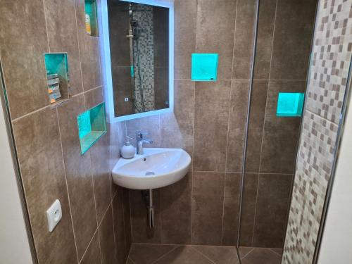 a bathroom with a sink and a mirror at Vybavený byt in Krásno