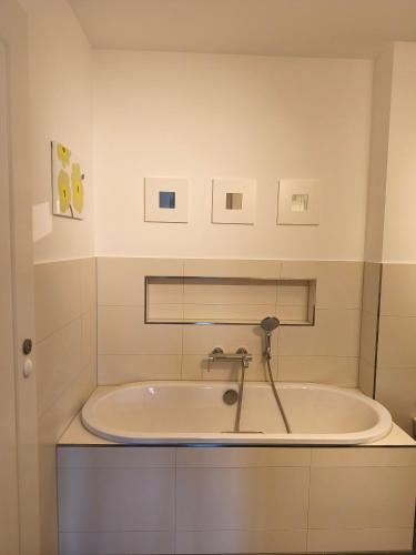 a bath tub with a faucet in a bathroom at Am Schlosspark Potsdam in Potsdam