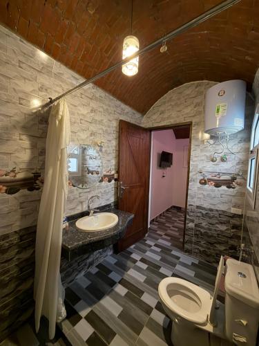 a bathroom with two sinks and a toilet and a shower at KR Hotel in Luxor