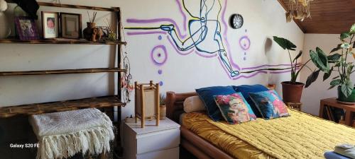 a room with a bed with pillows on it at Le Grenier d'Artiste in Laguépie