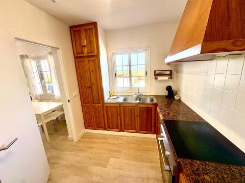 a kitchen with a sink and a counter top at Santa Brígida in Cala en Porter