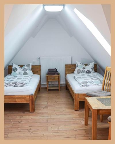 two beds in a room with a attic at Schwarzwaldpension Tuttlingen in Tuttlingen