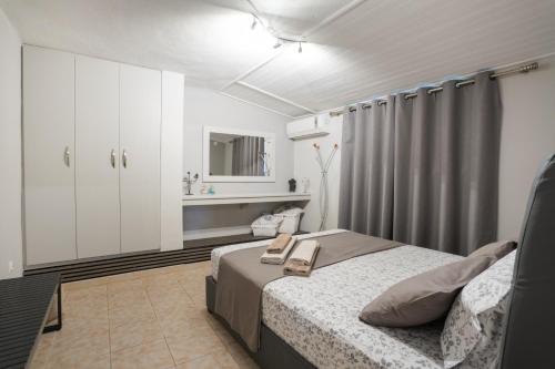 a bedroom with a bed and a sink in it at Cuervo Poolside Villa in Kalívia Thorikoú