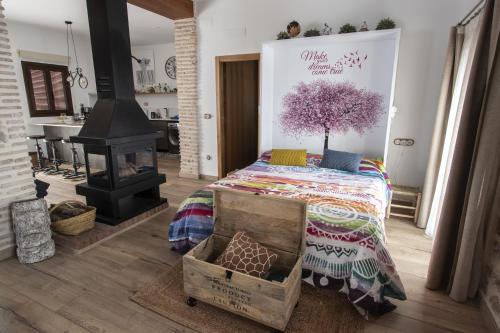 a bedroom with a bed and a wood stove at La Cambra casa rural Premium in Potríes