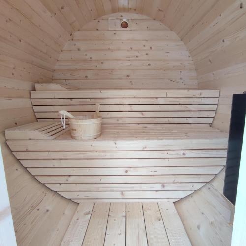 an inside of a sauna with a bucket in it at Łemkowska Izba in Wysowa-Zdrój