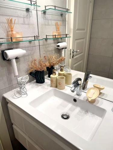 a bathroom with a white sink and a mirror at Ama Hyg Atelier Copenhagen-Delicius apartment near the Beach,Metro, Airport in Copenhagen