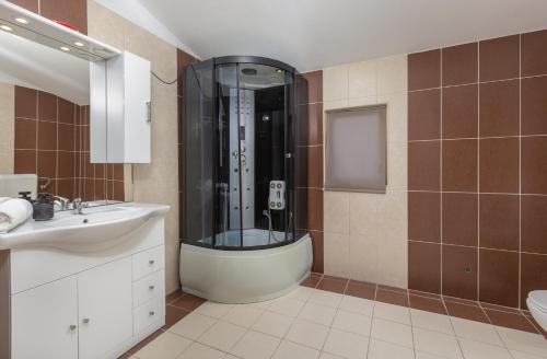 a bathroom with a shower and a sink at Peacefull Apartment with Garden and Barbeque in Biograd na Moru