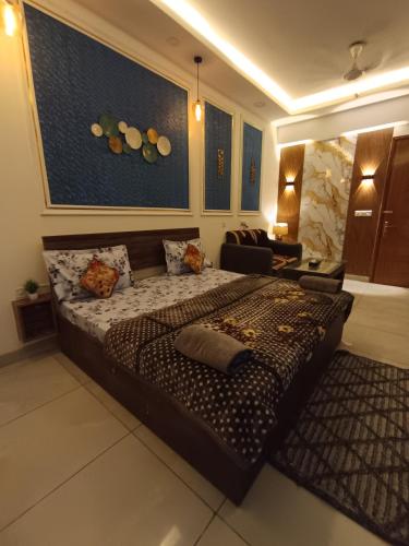 a bedroom with a large bed in a room at Darshana Studios#Cozy in Noida