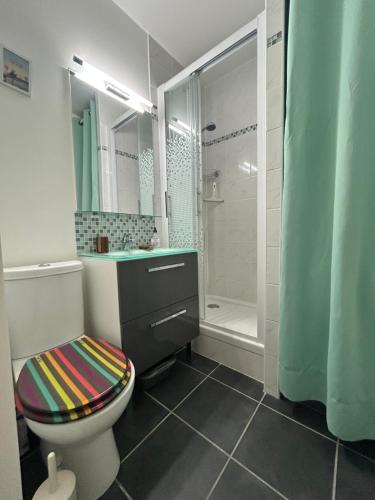 a bathroom with a toilet and a shower at La case du trimaran in Cabourg