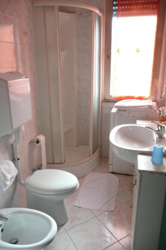 a bathroom with a toilet and a sink at Hotel Flora in Milano Marittima