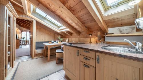 a kitchen with a sink and a large window at Landhaus Am Arzbach in Bad Tölz