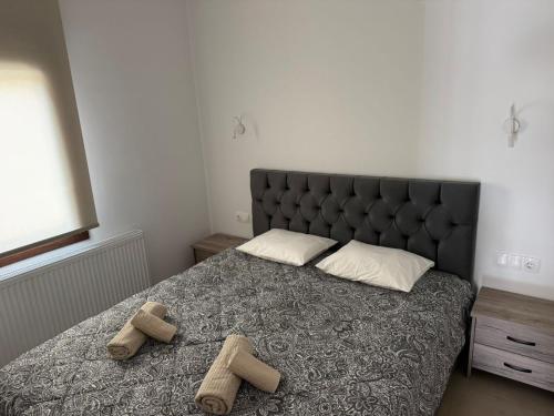 a bedroom with a bed with two pairs of shoes on it at Alexander in Ierissos