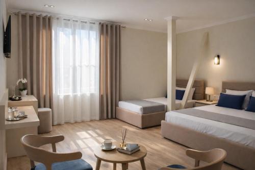a hotel room with a bed and a table and chairs at OKEJ Hotel in Golem