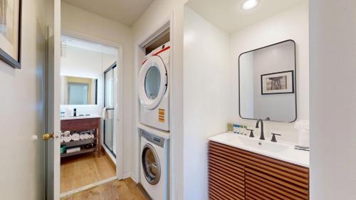 a bathroom with a sink and a washing machine at The Forum in Ocean City