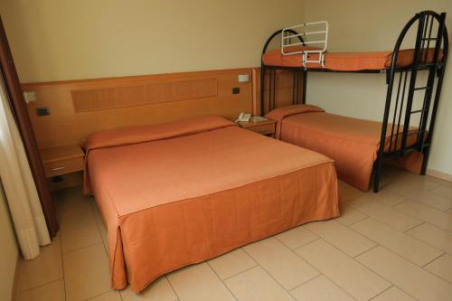 two beds in a room with two bunk beds at Hotel Panorama in Cambiano