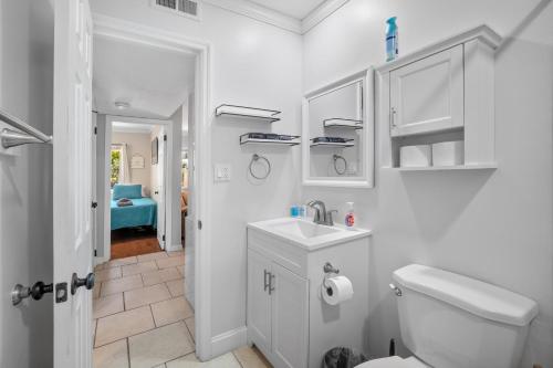 a white bathroom with a toilet and a sink at 5 MIN WALK TO BEACH- 2BR1BA Villa in The Dunes in Hilton Head Island