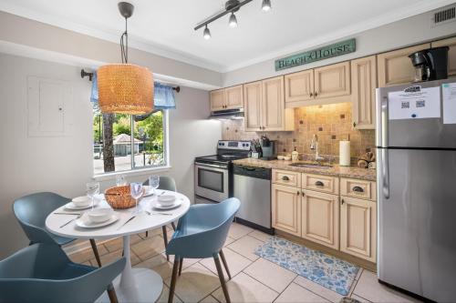 a kitchen with a table and chairs and a refrigerator at 5 MIN WALK TO BEACH- 2BR1BA Villa in The Dunes in Hilton Head Island