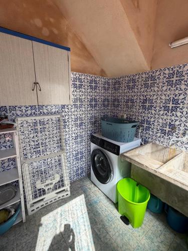 a laundry room with a washing machine and a sink at Ca'n Claret in Llucmajor